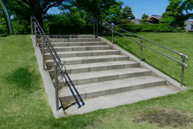 Exterior concrete access steps and landing with handrails