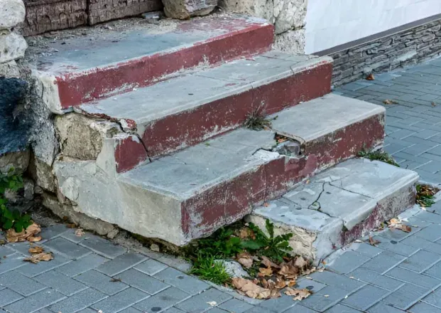 Broken and crumbling concrete edges on exterior steps