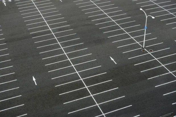 Striped asphalt parking lot viewed from above