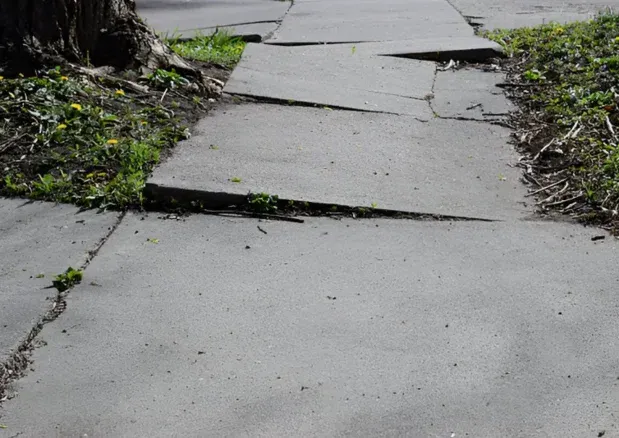 Concrete walking surface with lifted and displaced panels